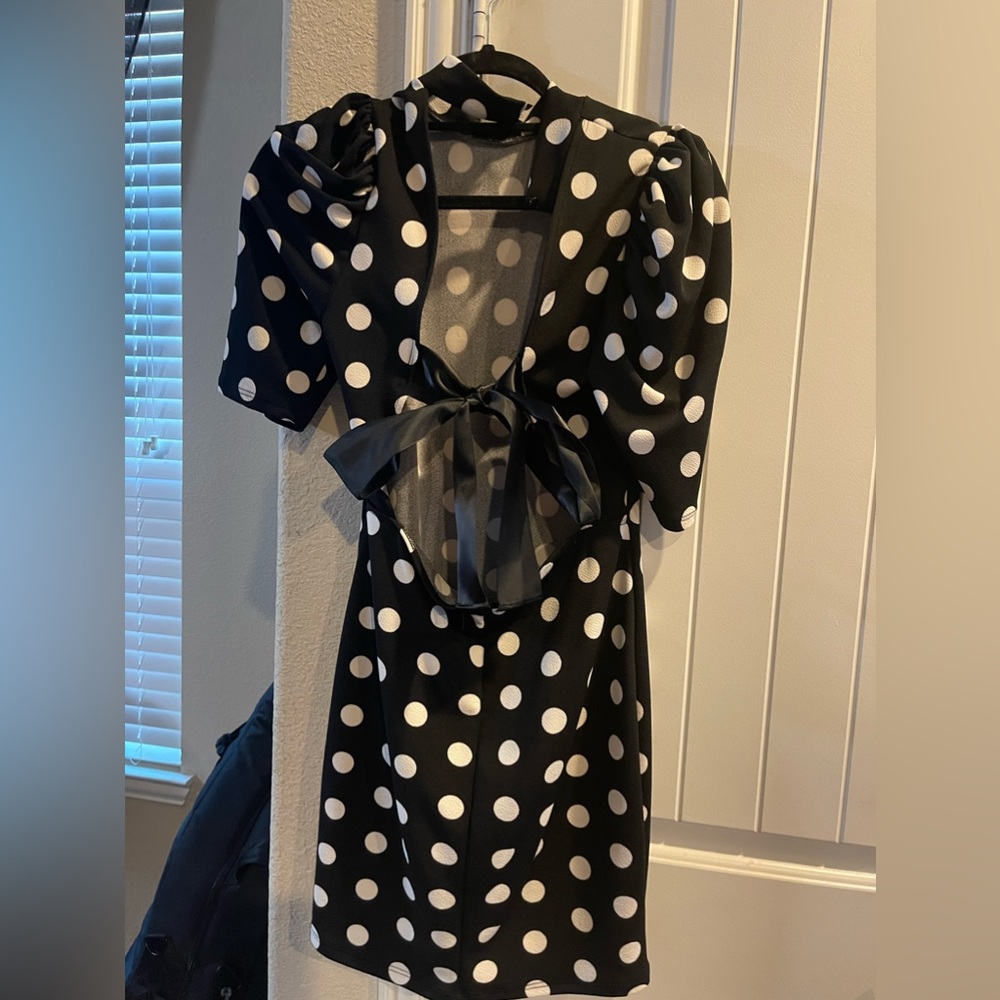 Medium Black and White polka dot mini dress with Bow in back.